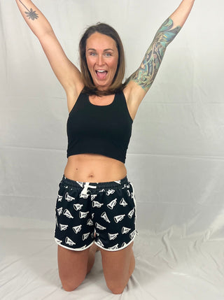 Close-up view of the pom-pom details and drawstring waistband on the Shake Your Pom Poms Drawstring Everyday Shorts.