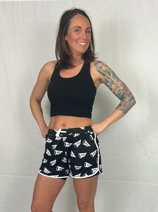 Close-up view of the pom-pom details and drawstring waistband on the Shake Your Pom Poms Drawstring Everyday Shorts.