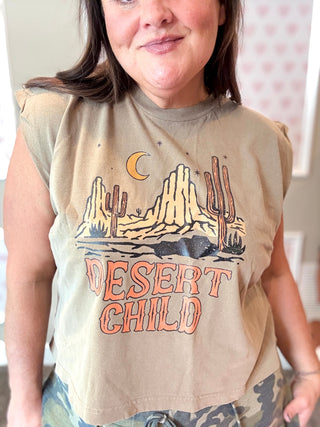 Person wearing a 'Desert Child' graphic t-shirt with a desert landscape design.