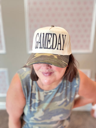 Person wearing a 'GAMEDAY' cap in an indoor setting