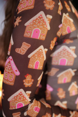 Brown leggings with gingerbread house and gingerbread man pattern.