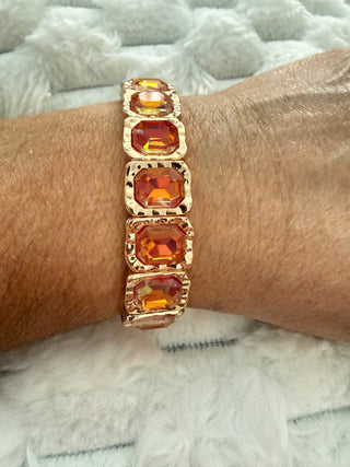 Gold stretch bracelet with faceted crystal gemstones available in multiple colors.
