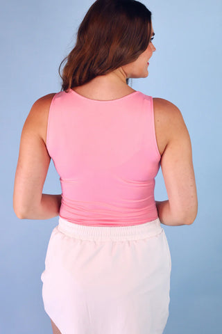 Pink v-neck bodysuit with a fitted silhouette, double-lined front for coverage, and snap closure, styled for everyday layering and casual outfits.