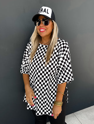 Woman wearing the Check Me Out Side Split Top, styled casually with jeans or a skirt for a trendy, laid-back look.