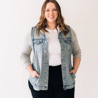 Model wearing Hooded Denim Jacket featuring classic denim body and soft gray hoodie lining.