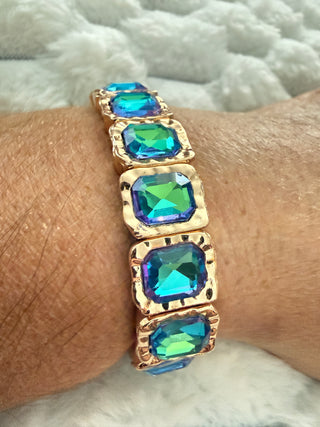 Gold stretch bracelet with faceted crystal gemstones available in multiple colors.