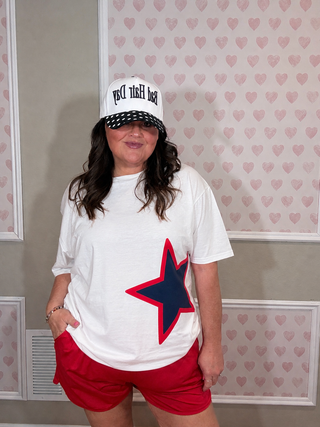 White patriotic star graphic tee paired with red shorts, casual women’s boutique summer outfit