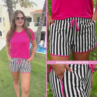 Black and white striped mid-rise everyday shorts with pink accents, relaxed fit, drawstring tie waist, and side pockets, styled for casual spring and summer wear.