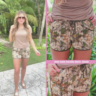 Camo printed mid-rise everyday shorts with a relaxed fit, drawstring tie waist, and side pockets, styled for casual spring and summer wear.