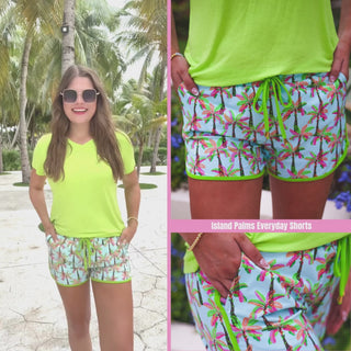 Island palms printed mid-rise everyday shorts with a relaxed fit, drawstring tie waist, and side pockets, styled for casual spring and summer wear.