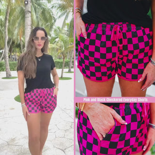 Black and pink checkered mid-rise everyday shorts with a relaxed fit, tie waist drawstring, and side pockets, styled for spring and summer casual wear.
