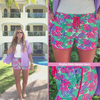 Paradise palms printed mid-rise everyday shorts with a relaxed fit, drawstring tie waist, and side pockets, styled for casual spring and summer wear.