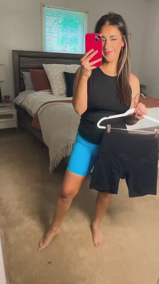 Woman wearing the Sasha Suck & Tuck Biker Short, styled for a chic, comfortable look.