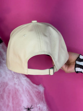 Cream canvas crown and black canvas bill snapback hat with “Spooky Vibes” Halloween embroidery; adjustable fit for festive fall style.