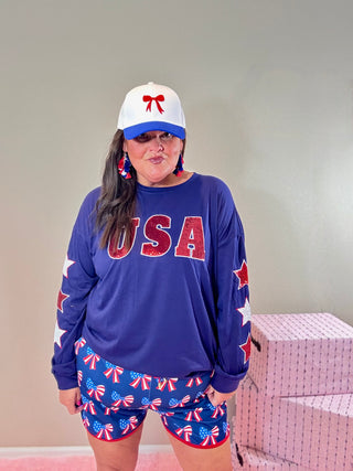 Patriotic Sequin USA Top with Star Sleeves – USA Sequin Star Top featuring sparkling sequin letters and embroidered star sleeve accents.