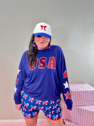 USA Sequin Top with Embroidered Star Sleeves – Bold and patriotic top with sequin "USA" lettering and star outline sleeves.