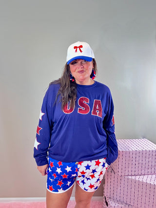 Sequin USA Graphic Top with Star Detail – Soft, stretchy top featuring sparkling sequin "USA" lettering and star embroidery on sleeves.