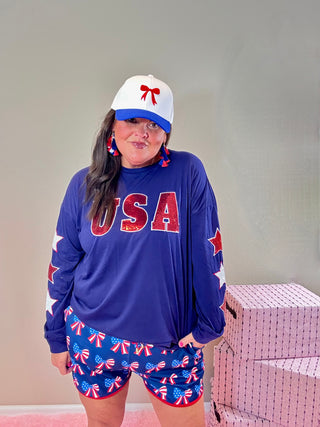 USA Sequin Star Top with Embroidered Sleeves – Patriotic top featuring sparkling sequin "USA" lettering and star outline sleeves, perfect for Fourth of July.