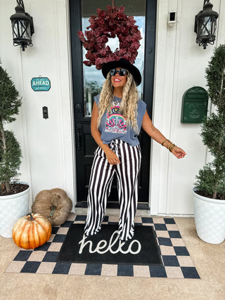 Soft, stretchy wide-leg pants with vertical stripes, elastic waistband with faux drawstring, and side pockets — flattering and comfy everyday style.